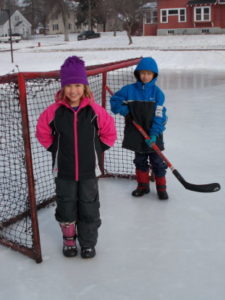 Two kids on ice rink