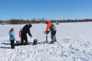 picture of people on frozen lake ice fishing